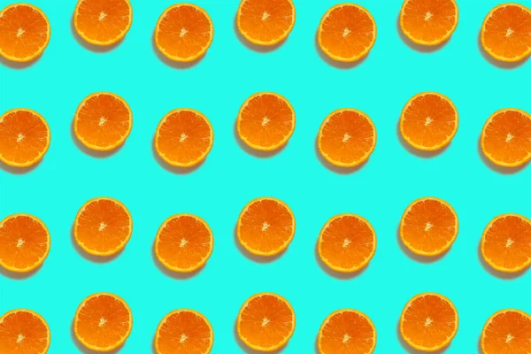 Half cut oranges pattern isolated on blue background. Fresh. Nature.