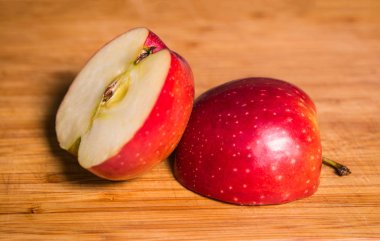 Tahta bir tahta üzerinde kırmızı dilimlenmiş elma