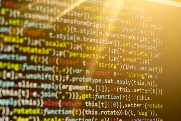 Minificated web ontwikkeling javascript-code in de zonsondergang stralen. Web ontwikkelaar werkplek. Abstracte informatie moderne digitale technologie. — Stockfoto