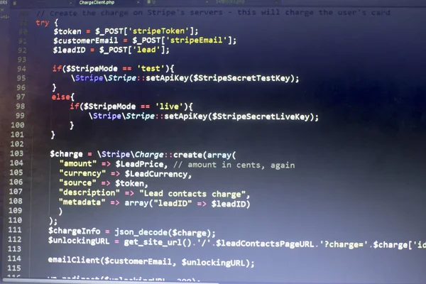 Web developer PHP code close up. Charging customer using Stripe API. Online payments processing. Abstract information technonology modern background. Concept screen of web developer.