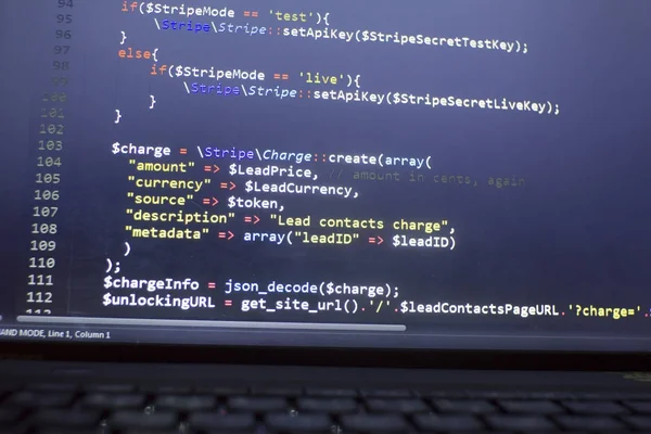 Web developer PHP code close up. Charging customer using Stripe API. Online payments processing. Abstract information technonology modern background. Concept screen of web developer.