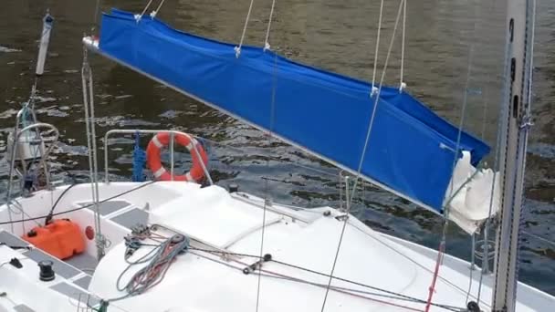 Moored yacht with a blue sail — Stock Video