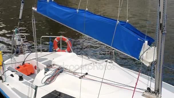 Moored yacht with a blue sail — Stock Video