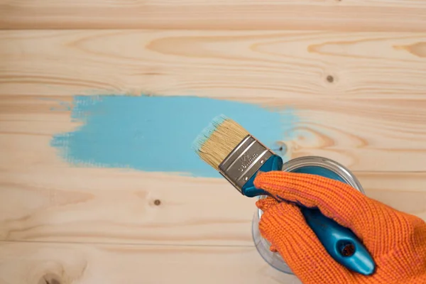 worker paints board
