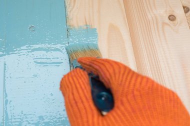 alt kurulu mavi boya boyar. onarım, kopya alanı, metin için yer kavramı. çalışan boyalar ahşap bir masa