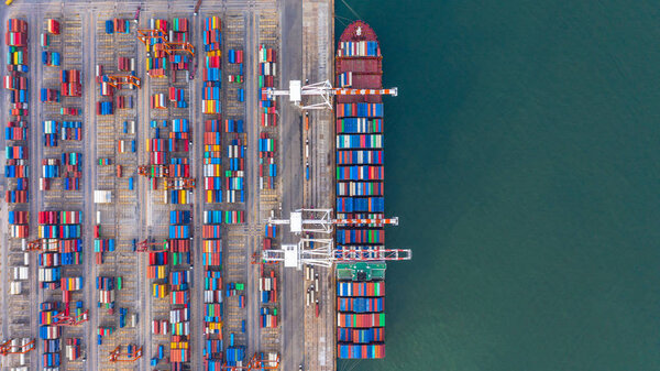 Container ship loading and unloading in deep sea port, Aerial to