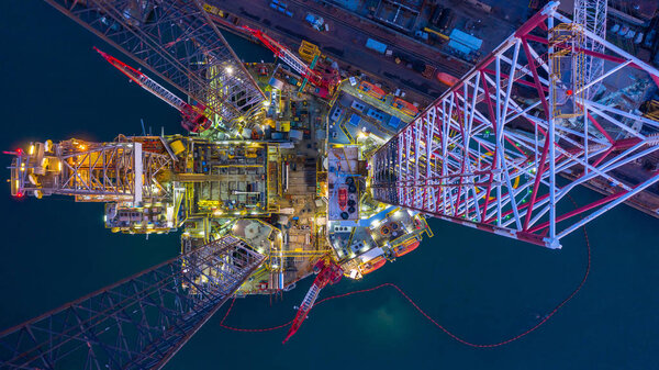 Aerial view offshore jack up rig  at night, Offshore oil rig dri