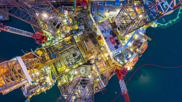 Aerial view offshore jack up rig  at night, Offshore oil rig dri