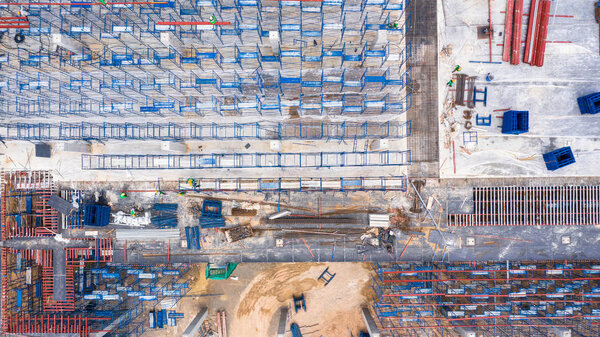 Aerial top view construction site with industrial consgruction machinery building for new factory buildings.