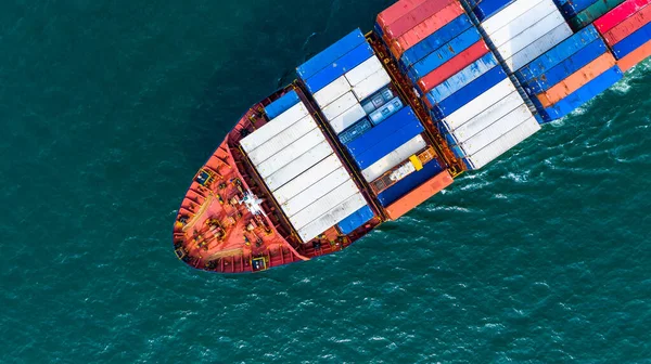 Aerial view cargo container ship carrying container for import and export, business logistic and freight transportation by ship in open sea.