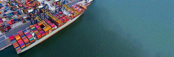 Container ship carrying container box in import export with quay crane, Global business cargo freight shipping commercial trade logistic and transportation oversea worldwide by container vessel.