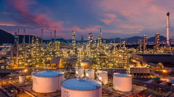Alacakaranlıkta petrol depolama tankı ve petrokimya fabrikası endüstriyel arka planına sahip petrol rafinerisi, alacakaranlıkta hava manzaralı petrol ve gaz rafinerisi.