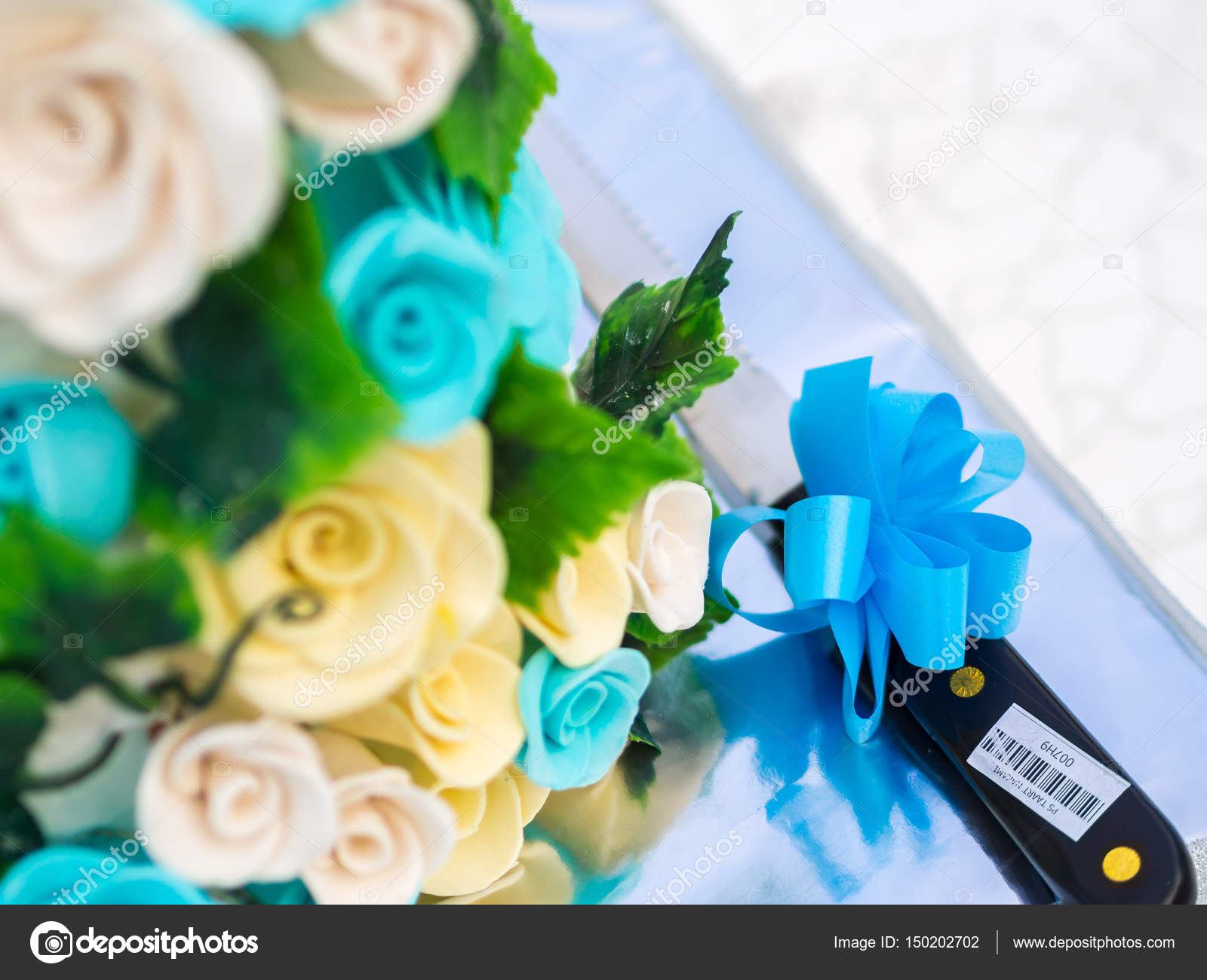 Knife Beside Floral Decoration On Wedding Cake Stock Photo