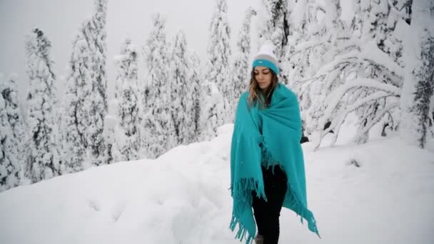女の子は、格子縞の美しい冬の森を歩いています。. — ストック動画