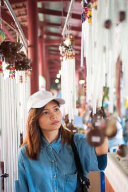 Bir şapka giymiş bir genç kadın bir Asya ülkesi, Tayland Pazar sokaklarında yürüyor