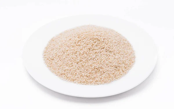 White Sesame Seeds on white plate at on white background — Stock Photo, Image
