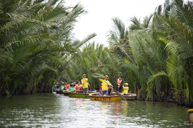HOI AN,VIETNAM-December 9,2019: Tourists enjoy round basket boat Made of bamboo is a unique Vietnamese at Cam thanh village.