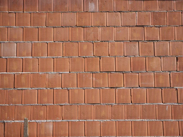 New brick wall built of red bricks on mortar. Background for construction work. — Stock Photo, Image