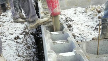 İşçilerin inşaat alanında, zemin çalışır çalışır. Ayrıntılı döküm pompa müstakil ev temelleri için beton. Beton pompa, arka planda gökyüzü