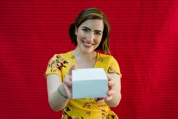 smiling woman with gift in hands