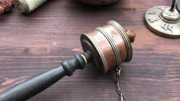 Copper Buddhist prayer wheel on a wooden brown table, the increase in closeup — Stockvideo