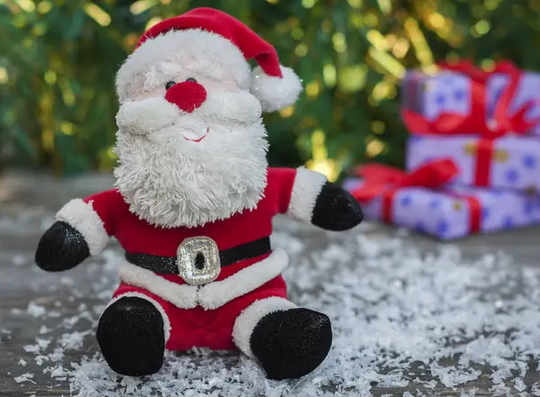 Санта Клаус на серой деревянной поверхности со снегом — стоковое фото