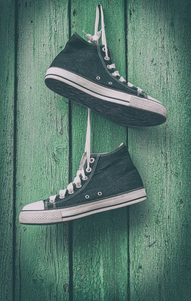 Pair of blue men's sneakers hanging laces — Stock Photo, Image