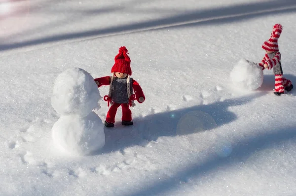 Two toy little man rolled a snowball — Stock Photo, Image