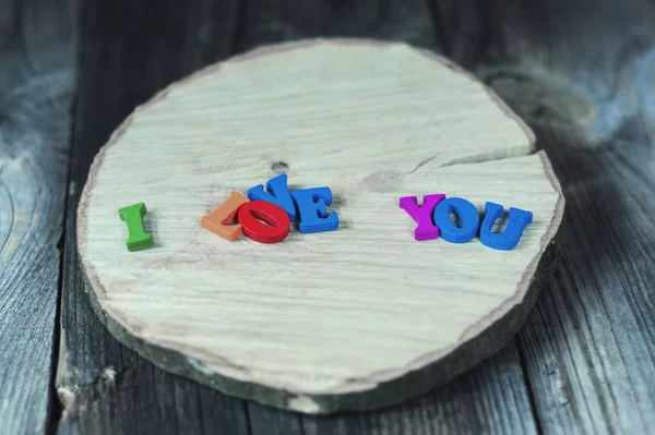 Inscription of the small colored wooden letters I love you — Stock Photo, Image