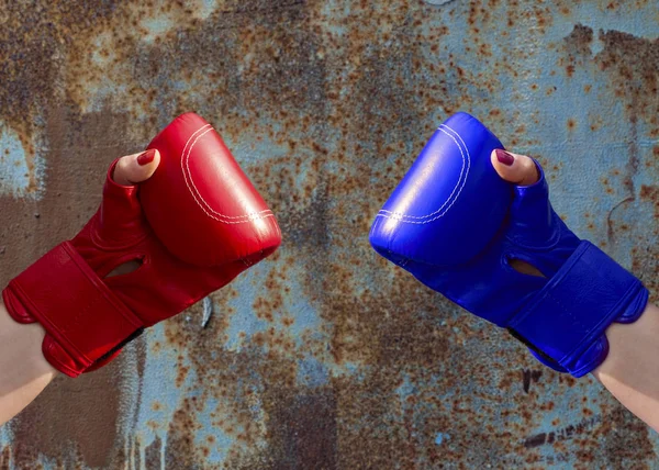 Two female hands in red and blue boxing gloves — Stock Photo, Image