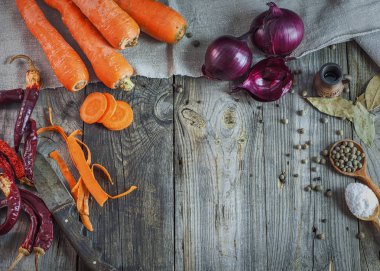 Taze sebze havuç ve soğan gri bir ahşap yüzeye