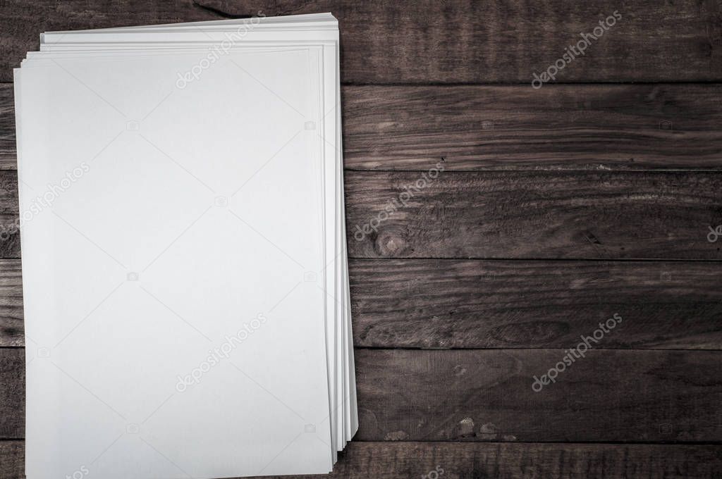 stack of sheets on white brown wooden surface