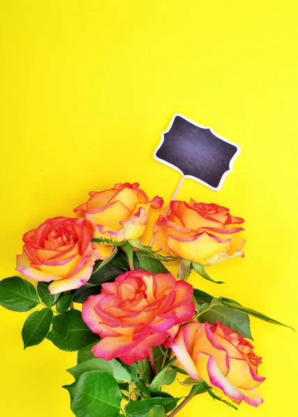 Boeket van vijf rozen met een lege zwarte plaat — Stockfoto