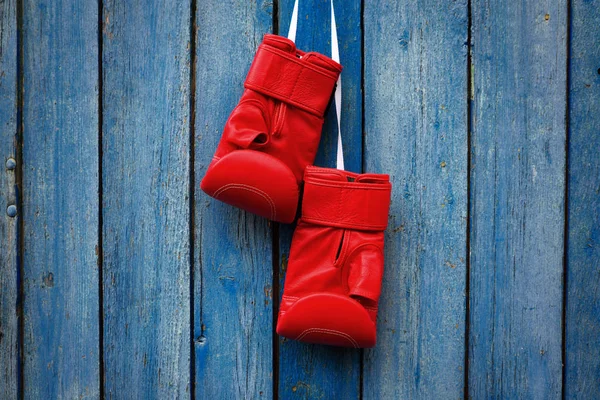 Par röda handskar för kickboxning hängande på en vit lina — Stockfoto