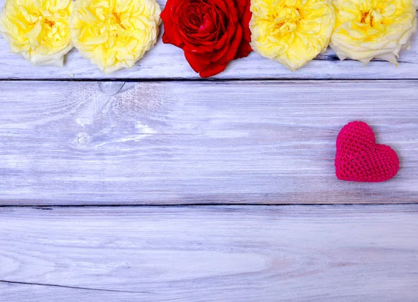 Red knitted heart on a white wooden background Royalty Free Stock Photos