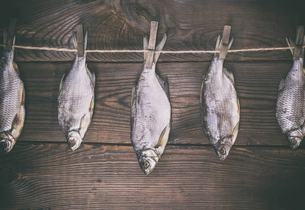 stock image fish ramming in scales hanging on a rope 