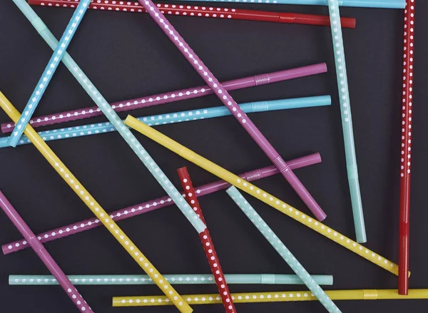 Plastic tubes in a white polka-dot for drinks — Stock Photo, Image