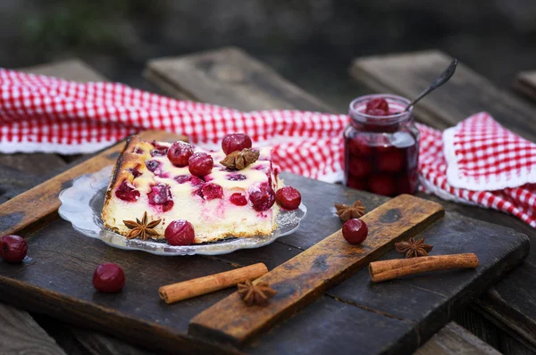 piece of cottage cheese cake and cherry berries on a glass plate