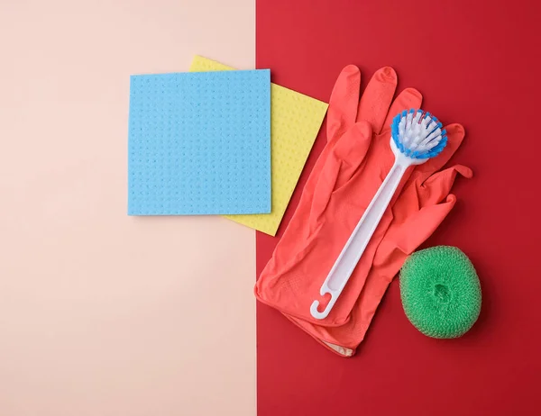 Items for home cleaning: red rubber gloves, brush, multi-colored — Stock Photo, Image