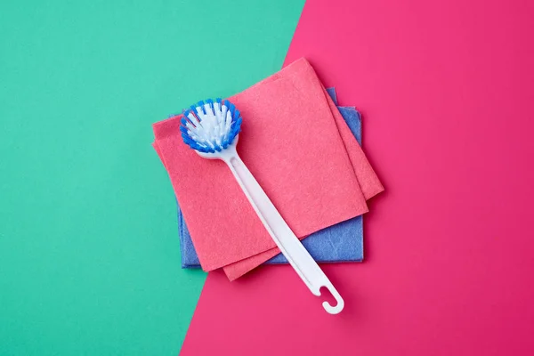Plastic white brush with handle and multi-colored square dishwas — Stock Photo, Image