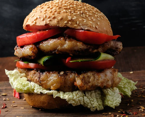 hamburger with pork fried steak, red tomatoes