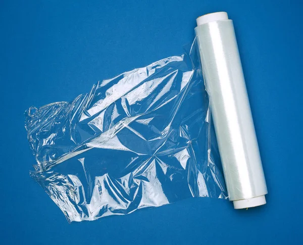 Big roll of wound white transparent film for wrapping food, dark — Stockfoto