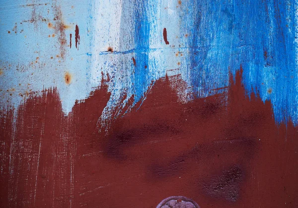 Brown iron texture of rusty sheet with remains of blue paint — Stock Photo, Image