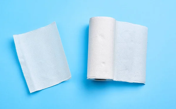 Rol van witte papieren handdoek op een blauwe achtergrond — Stockfoto
