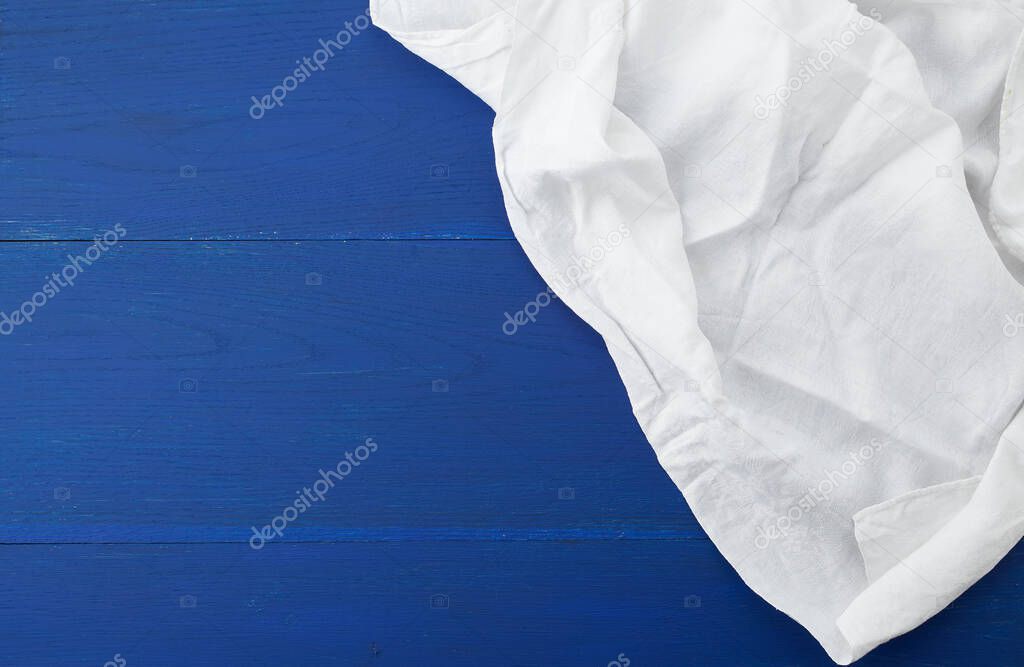 white kitchen textile towel folded on a blue wooden table from o