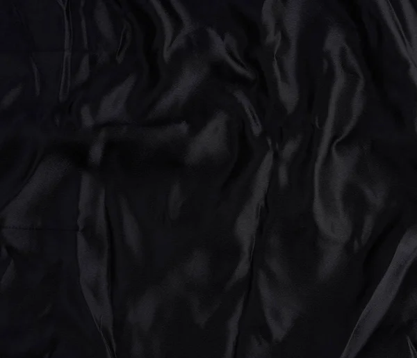 Černá saténová textilie, kus látky pro šití záclon — Stock fotografie