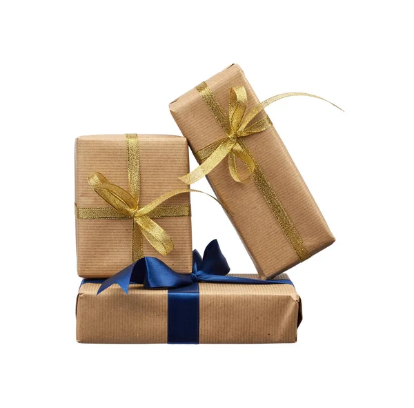 Stack of gifts wrapped in brown kraft paper and tied with a silk — Stok fotoğraf