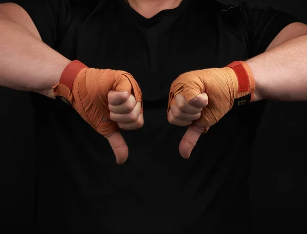 Athlete in black uniform and hands rewound with textile orange b — Stock Photo, Image