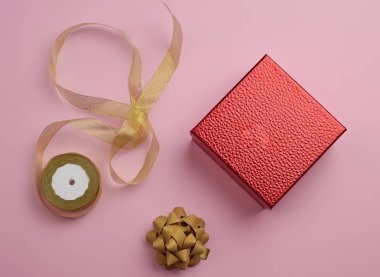 square red box tied with a golden ribbon