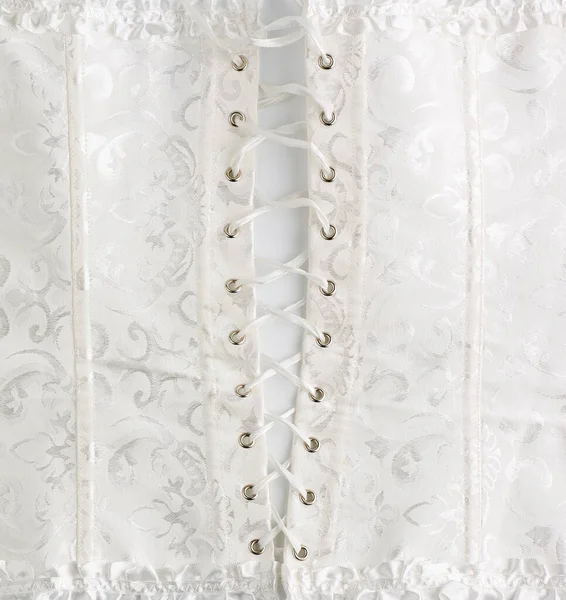 Fragment białego satynowego gorsetu z koronką, widok z tyłu, tkanina — Zdjęcie stockowe